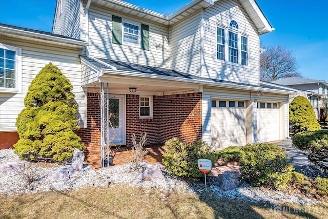 47 Lynnwood Rd, Edison, NJ 08820 - view of front facade with an attached garage, brick siding, and driveway