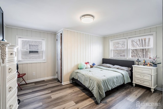 bedroom with wood finished floors and baseboards