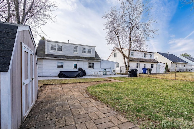 rear view of property with a patio area, a lawn, and fence