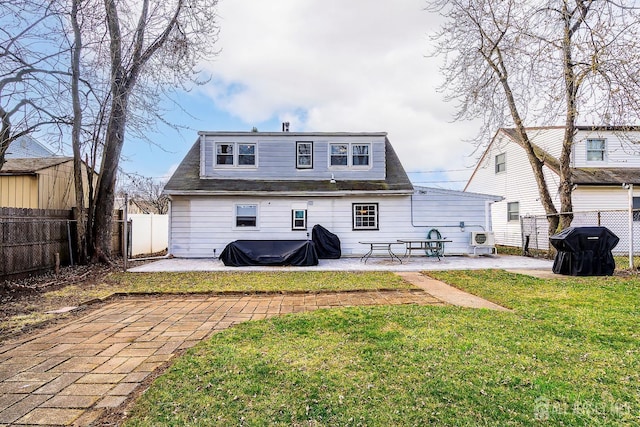 rear view of house featuring a patio, a fenced backyard, and a lawn