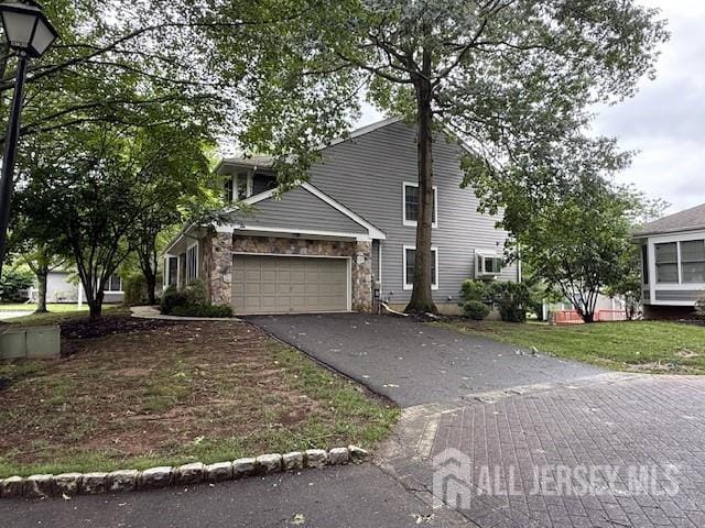 1 Cranberry Ct, South Brunswick, NJ 08540 - view of front of property featuring asphalt driveway, a garage, and stone siding