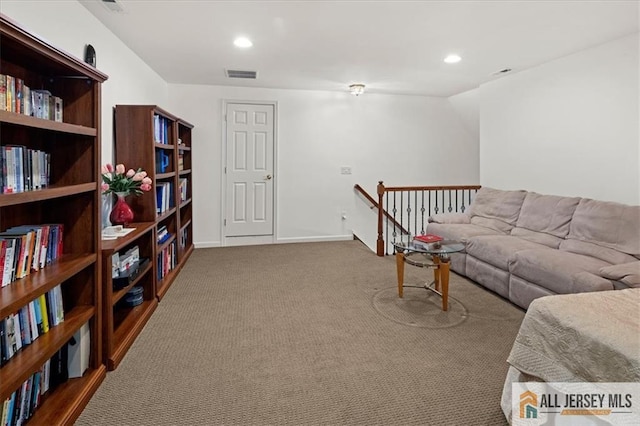 carpeted living room with recessed lighting, visible vents, and baseboards