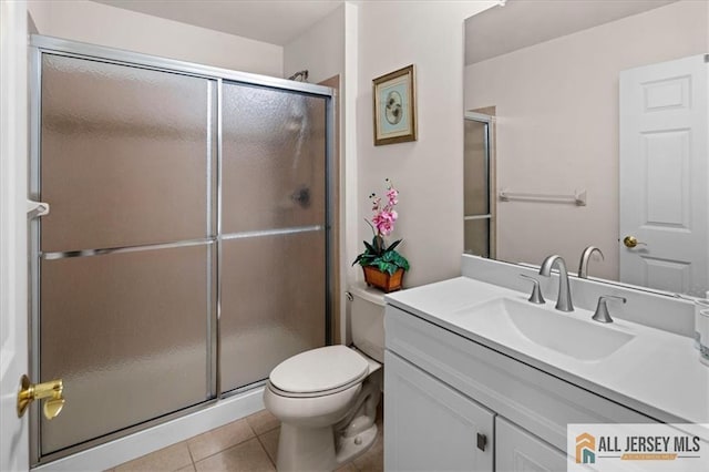 bathroom featuring toilet, a shower stall, and tile patterned floors