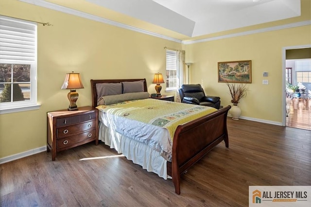 bedroom with ornamental molding, dark wood finished floors, and baseboards