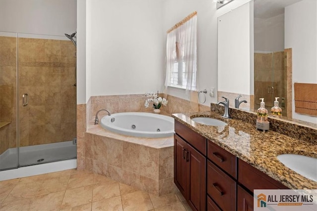 full bathroom with a whirlpool tub, a stall shower, a sink, and tile patterned floors