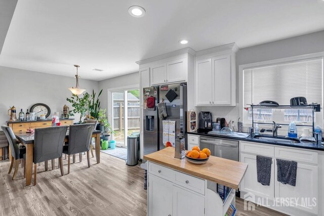 33 Altamont Rd, Edison, NJ 08817 - kitchen featuring a sink, butcher block counters, stainless steel appliances, white cabinetry, and decorative light fixtures
