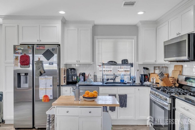 33 Altamont Rd, Edison, NJ 08817 - kitchen with appliances with stainless steel finishes, a sink, white cabinets, tasteful backsplash, and recessed lighting