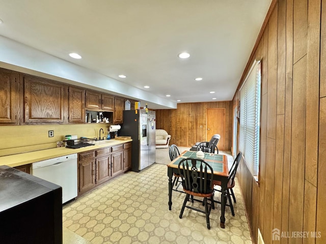 2 Jayne St, Old Bridge, NJ 08857 - kitchen with dishwasher, wood walls, stainless steel fridge with ice dispenser, recessed lighting, and a sink