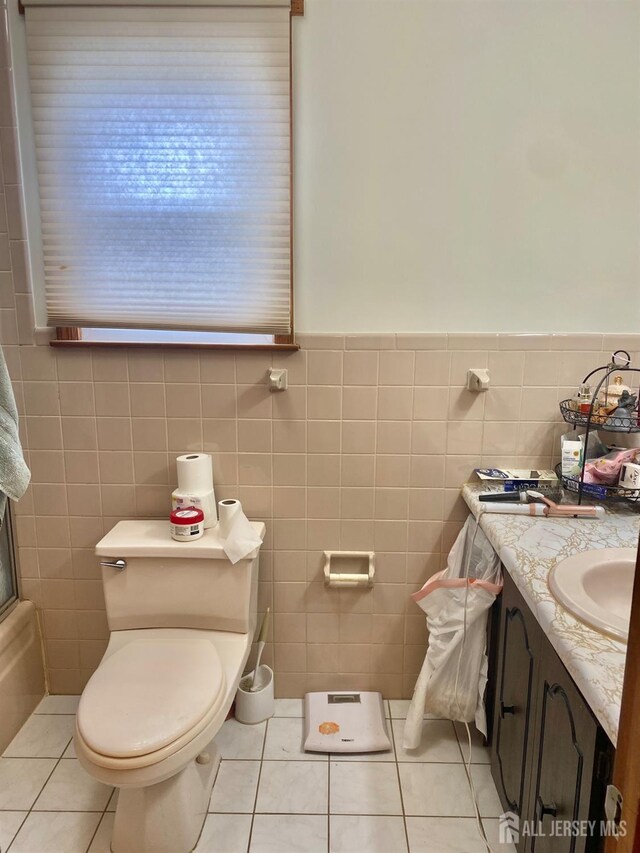 2 Jayne St, Old Bridge, NJ 08857 - bathroom with tile walls, tile patterned floors, toilet, vanity, and a shower