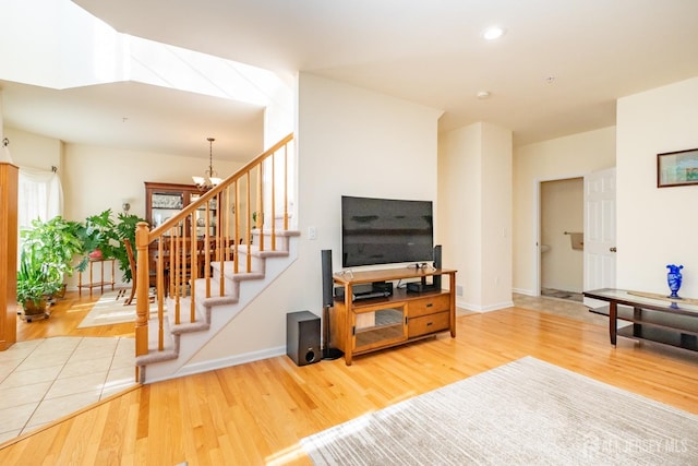 living room with hardwood / wood-style floors and a notable chandelier