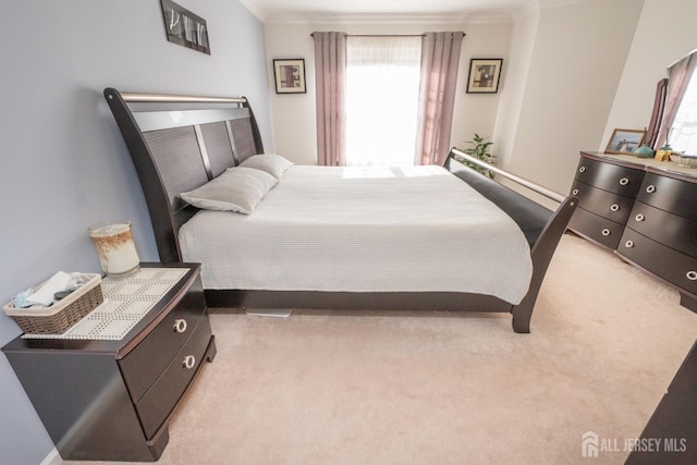 bedroom featuring light colored carpet and ornamental molding