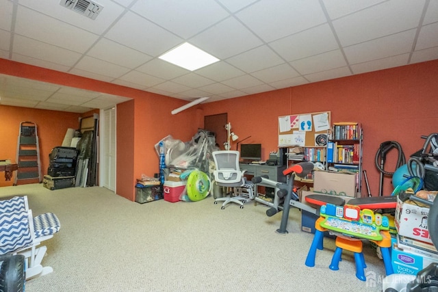 playroom featuring carpet flooring and a drop ceiling