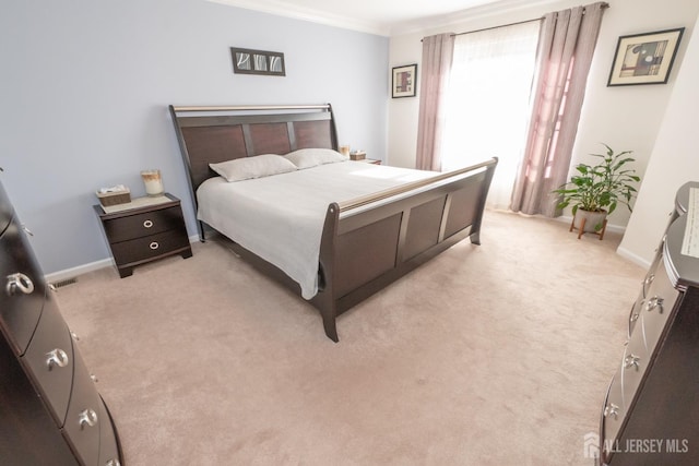 bedroom with light colored carpet and ornamental molding