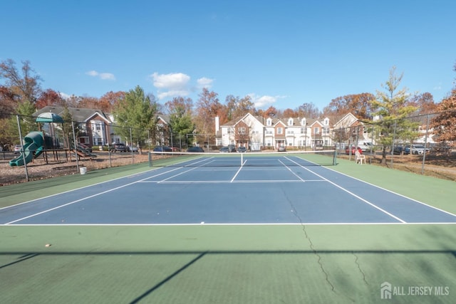 view of sport court with a playground