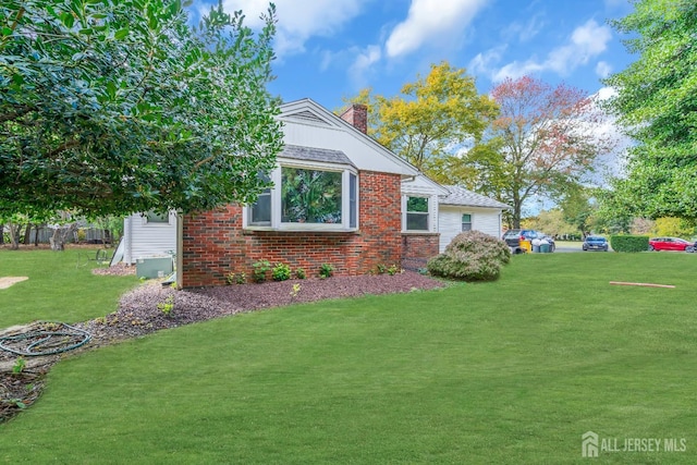 view of side of property with a yard