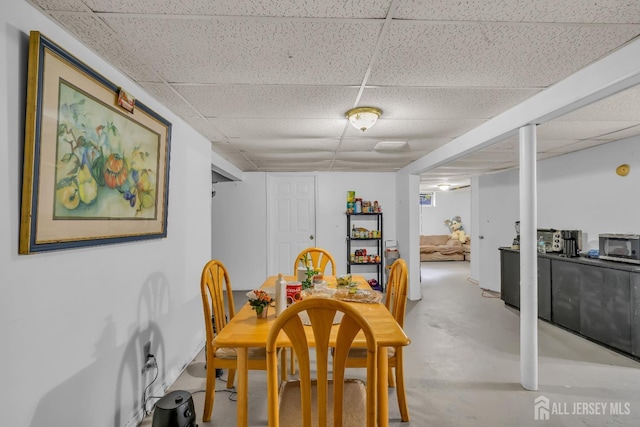 dining room featuring a drop ceiling