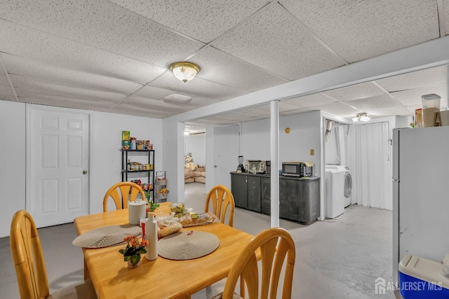 dining room featuring washer / clothes dryer and a drop ceiling