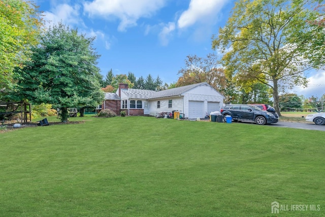 view of front of house with a garage and a front yard