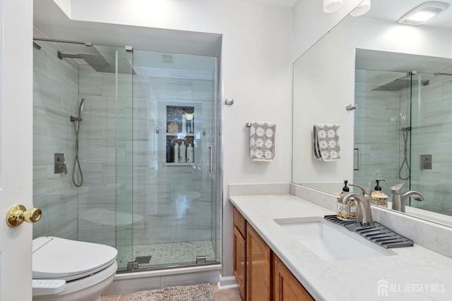 full bath featuring visible vents, toilet, a stall shower, and vanity