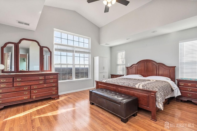 bedroom with visible vents, lofted ceiling, ceiling fan, and light wood finished floors