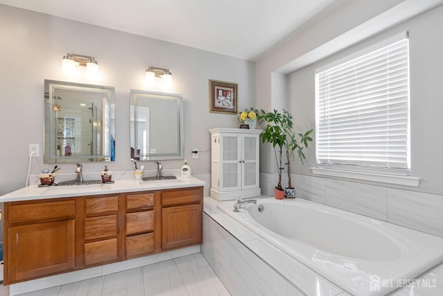 bathroom featuring a bath, a shower stall, double vanity, and a sink