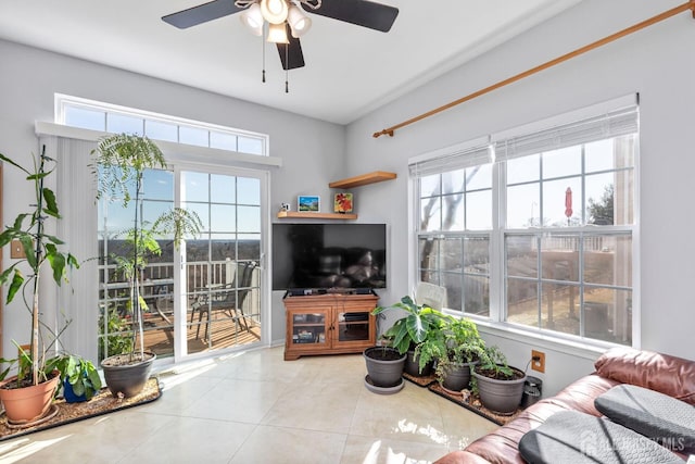 tiled living area with a healthy amount of sunlight and a ceiling fan