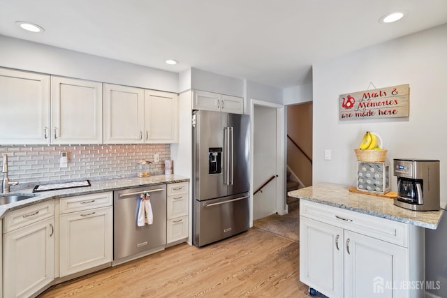 217 Fred Allen Dr, South Plainfield, NJ 07080 - kitchen with stainless steel appliances, light wood-style flooring, tasteful backsplash, light stone countertops, and recessed lighting