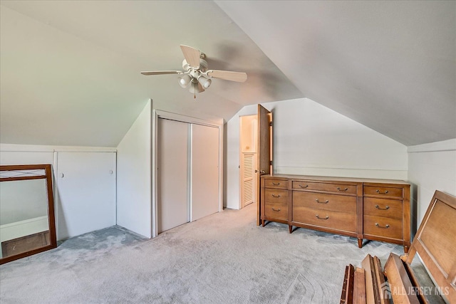 additional living space featuring a ceiling fan, vaulted ceiling, and light colored carpet