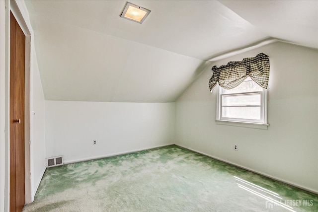 bonus room with baseboards, carpet, vaulted ceiling, and visible vents