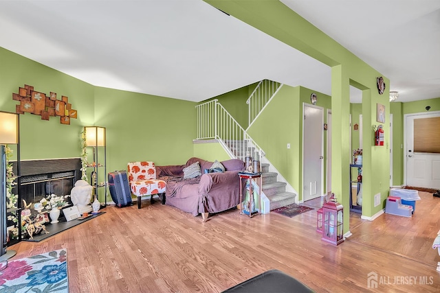 122 Salem Rd, North Brunswick, NJ 08902 - living room with wood finished floors, stairs, and a fireplace with raised hearth