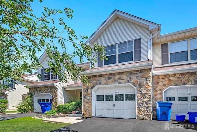 122 Salem Rd, North Brunswick, NJ 08902 - view of front facade featuring stone siding, a garage, and driveway