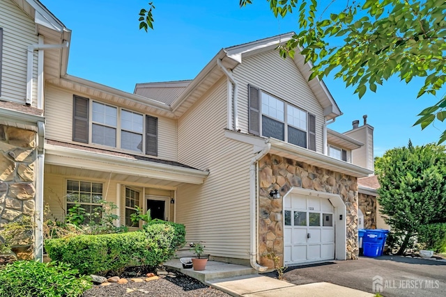 122 Salem Rd, North Brunswick, NJ 08902 - traditional home featuring stone siding, a garage, and driveway