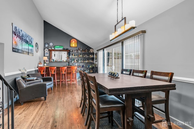 14 E Shirley Ave, Colonia, NJ 07067 - dining area featuring a bar, vaulted ceiling, and wood finished floors