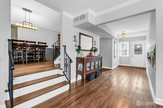 14 E Shirley Ave, Colonia, NJ 07067 - foyer entrance featuring stairs, wood finished floors, a chandelier, and crown molding
