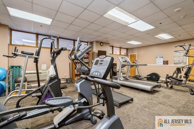 gym with carpet floors and a drop ceiling