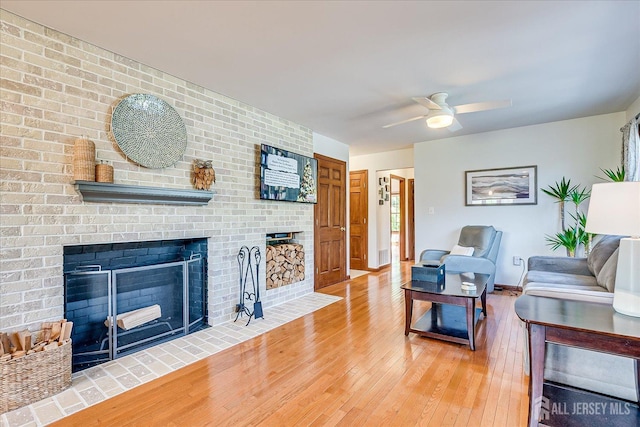 27 Vermont Ave, Franklin, NJ 08823 - living area featuring a brick fireplace, wood-type flooring, and a ceiling fan