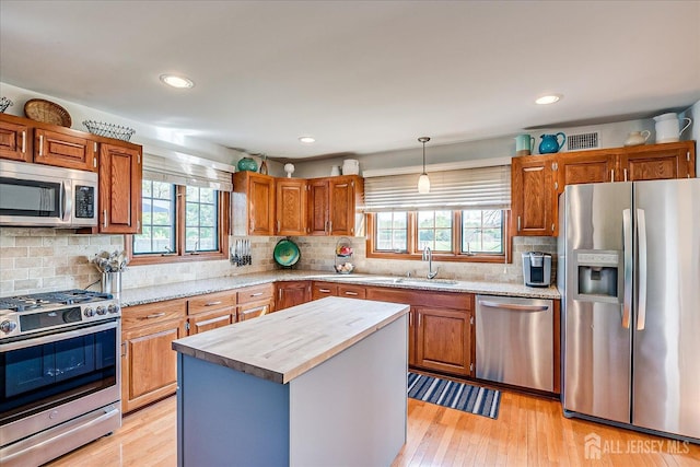 27 Vermont Ave, Franklin, NJ 08823 - kitchen featuring appliances with stainless steel finishes, plenty of natural light, light wood-type flooring, decorative backsplash, and recessed lighting