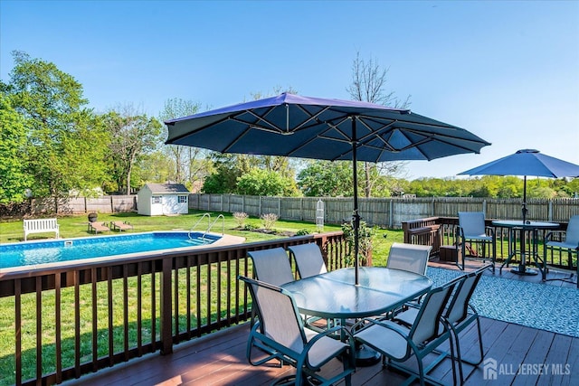 27 Vermont Ave, Franklin, NJ 08823 - deck with outdoor dining area, a fenced backyard, and a shed