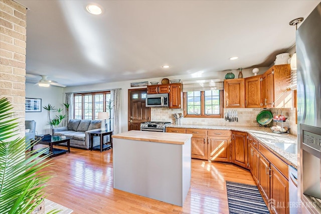 27 Vermont Ave, Franklin, NJ 08823 - kitchen with appliances with stainless steel finishes, plenty of natural light, light wood finished floors, a kitchen island, and recessed lighting