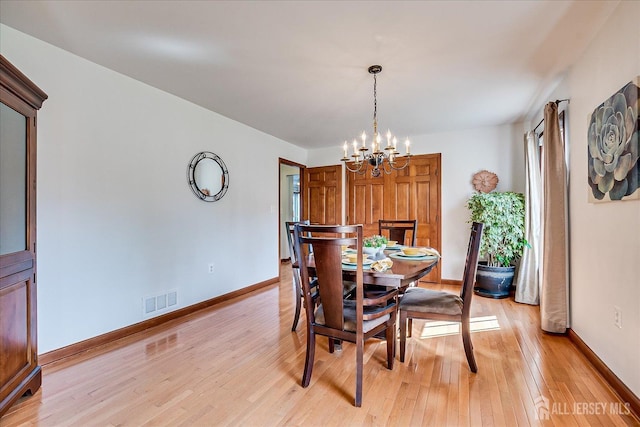 27 Vermont Ave, Franklin, NJ 08823 - dining area with a chandelier and light wood-style floors