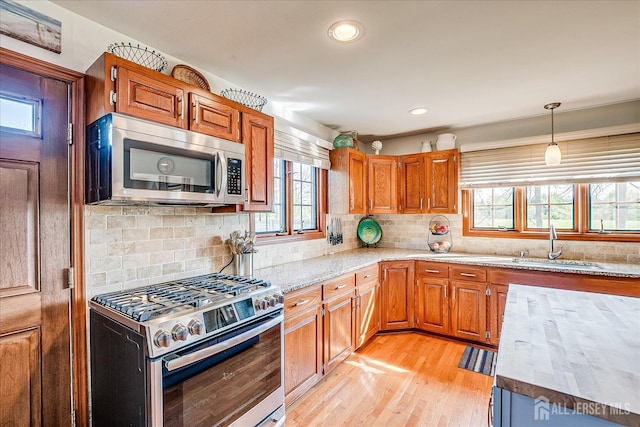 27 Vermont Ave, Franklin, NJ 08823 - kitchen featuring stainless steel appliances, plenty of natural light, brown cabinetry, and recessed lighting