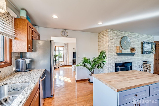 27 Vermont Ave, Franklin, NJ 08823 - kitchen with butcher block countertops, light wood-style flooring, decorative backsplash, stainless steel dishwasher, and recessed lighting