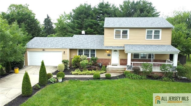 25 Tall Oaks Dr, East Brunswick, NJ 08816 - view of front of property featuring driveway, an attached garage, a front lawn, and covered porch