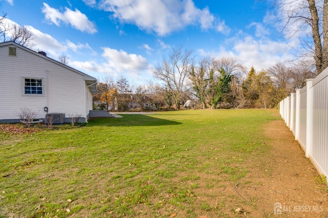 view of yard featuring fence and cooling unit