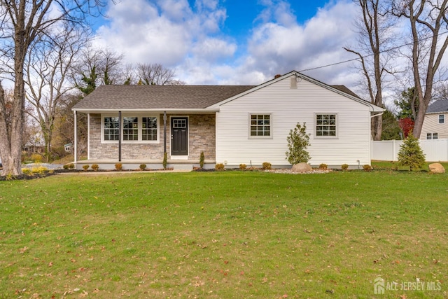 single story home featuring a porch, a front lawn, fence, and a shingled roof