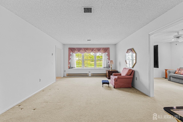 714 Victoria Ct Unit B, Monroe, NJ 08831 - sitting room with carpet flooring, a textured ceiling, baseboard heating, ceiling fan, and baseboards