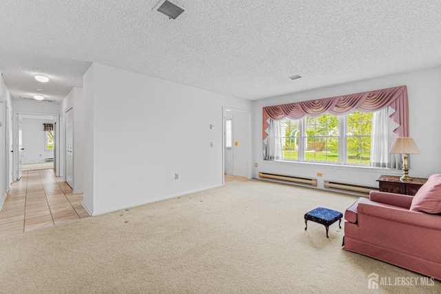 714 Victoria Ct Unit B, Monroe, NJ 08831 - living area with a baseboard heating unit, a textured ceiling, carpet floors, and tile patterned flooring