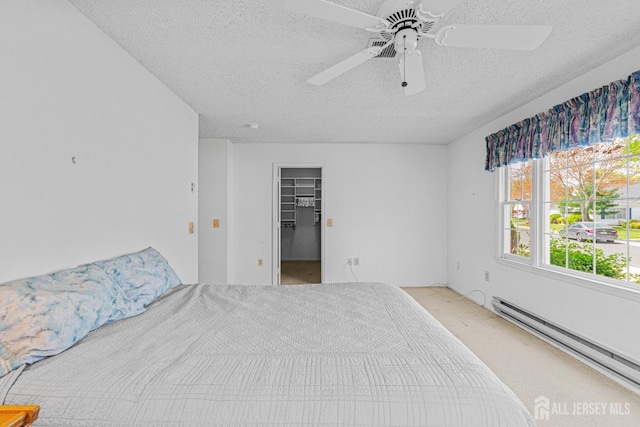714 Victoria Ct Unit B, Monroe, NJ 08831 - unfurnished bedroom featuring baseboard heating, a textured ceiling, a walk in closet, a ceiling fan, and a closet