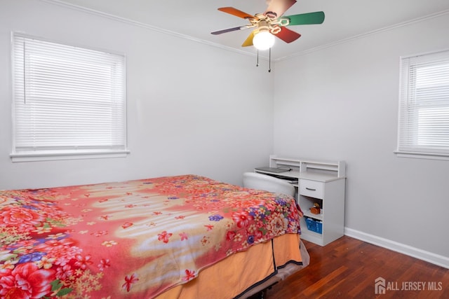 bedroom featuring dark wood-type flooring, ceiling fan, and ornamental molding