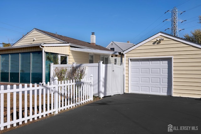 ranch-style house featuring a garage and an outbuilding